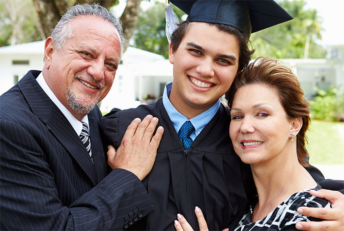 Family with recent graduate in cap and gown